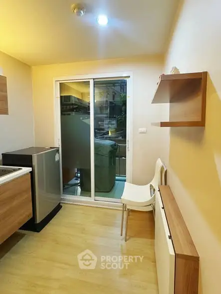 Modern kitchen with sliding glass door and wooden flooring