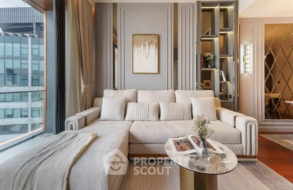 Elegant living room with plush cream sofa, chic decor, and floor-to-ceiling windows offering an urban view, perfect for upscale city living.