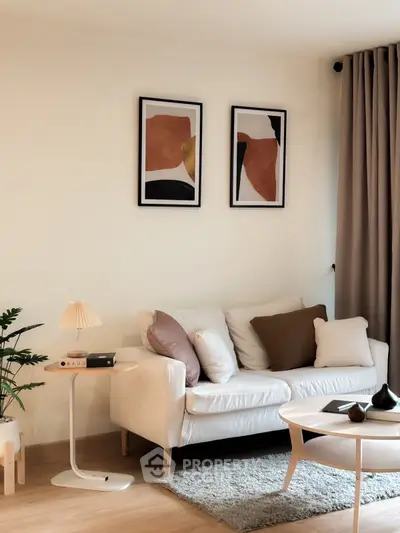 Stylish modern living room with cozy white sofa and abstract art decor.