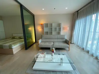 Modern living room with stylish decor and large windows offering city views