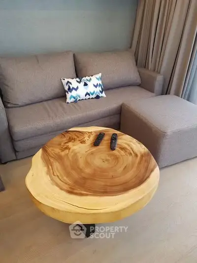 Stylish living room with unique wooden coffee table and modern sofa, perfect for cozy gatherings.