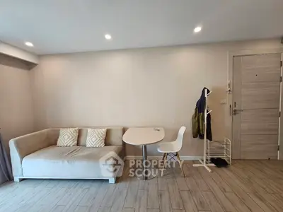 Modern living room with cozy sofa and dining area in minimalist design.