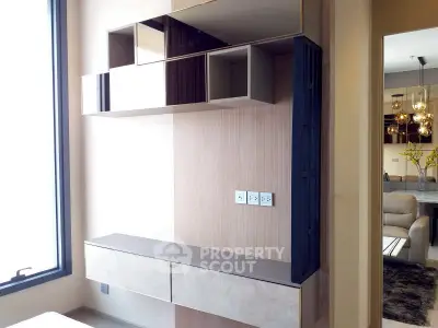 Modern interior with sleek storage and open layout, featuring stylish lighting and contemporary design.