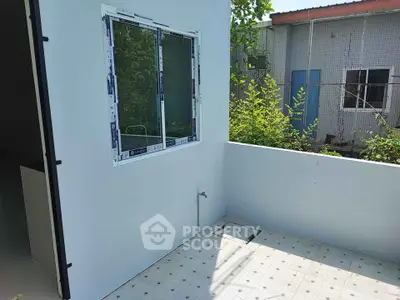 Charming balcony with lush greenery view, perfect for relaxation and outdoor enjoyment.