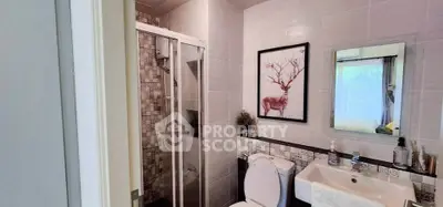 Modern bathroom with shower, stylish decor, and elegant fixtures in a contemporary home.