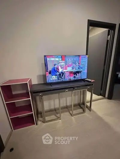 Modern living room with sleek TV stand and open shelving unit
