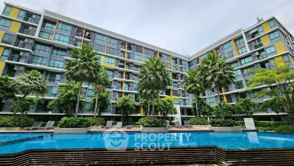 Modern condominium with lush greenery and inviting swimming pool