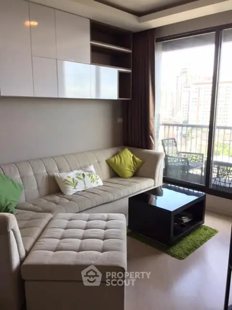 Modern living room with cozy seating and balcony view in urban apartment
