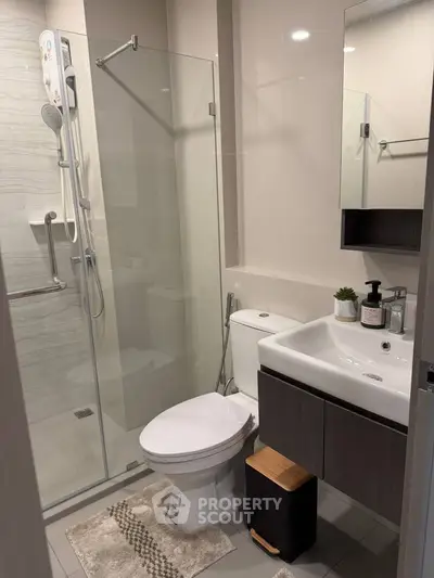 Modern bathroom with glass shower and sleek fixtures