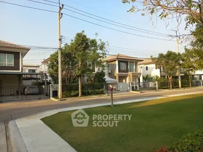 Charming suburban neighborhood with modern two-story homes and lush greenery.