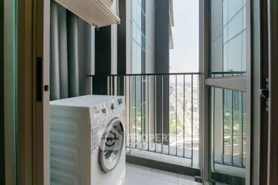 Modern apartment balcony with washing machine and city view