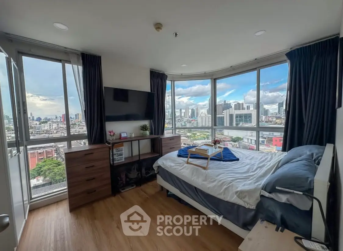 Spacious bedroom with panoramic city view and modern furnishings