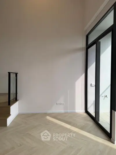 Spacious modern interior with large windows and elegant flooring, perfect for natural light lovers.