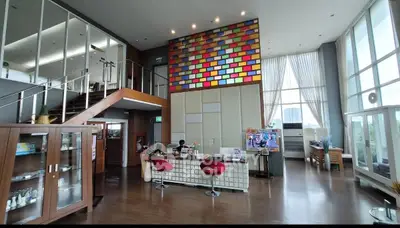 Spacious modern living area with colorful wall and large windows