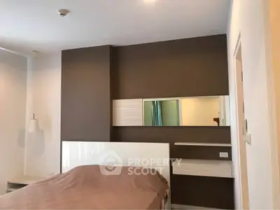 Modern bedroom with stylish brown accent wall and contemporary furnishings.