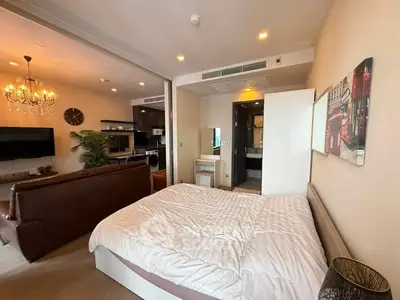Modern studio apartment with open layout, featuring cozy bedroom and stylish living area.