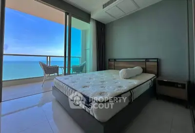 Luxurious bedroom with stunning ocean view and modern furnishings.