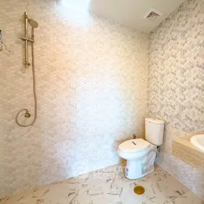 Modern bathroom with elegant tile design and sleek fixtures.