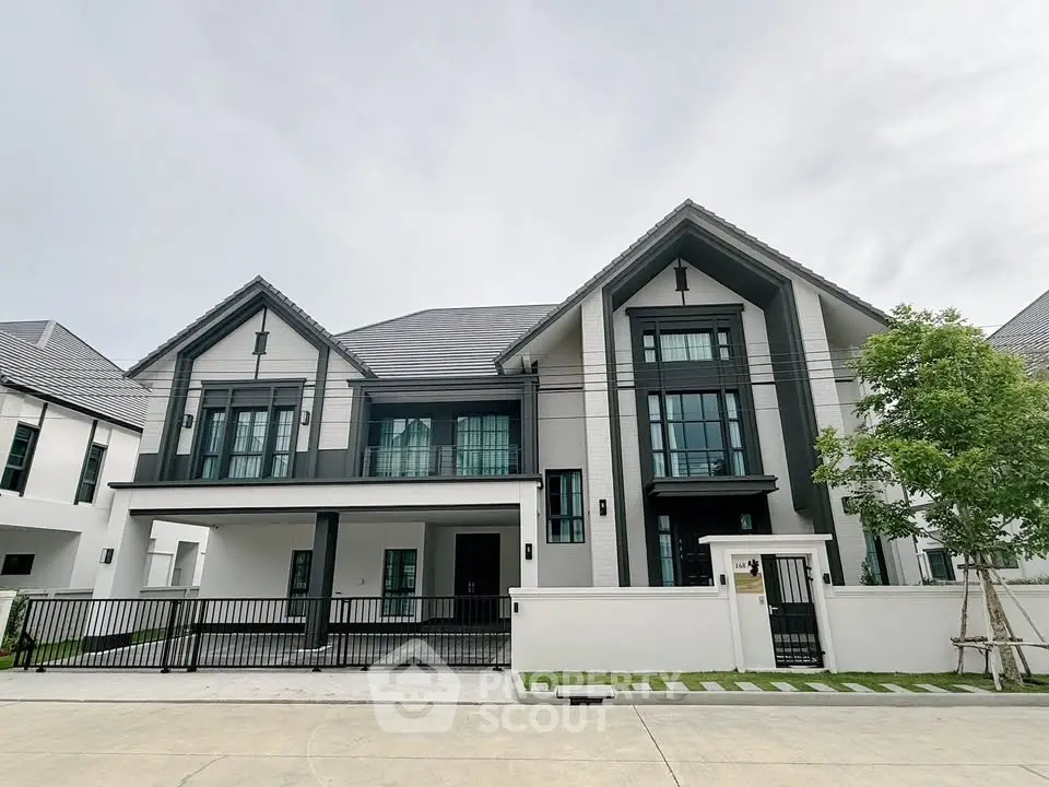Stunning modern two-story house with sleek design and spacious driveway in a serene neighborhood.