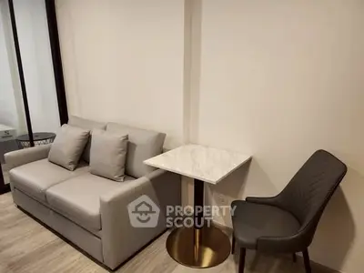 Modern living room with sleek sofa and elegant marble table in stylish apartment.