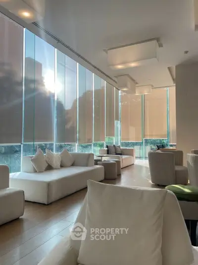 Luxurious modern living room with floor-to-ceiling windows and elegant furniture.