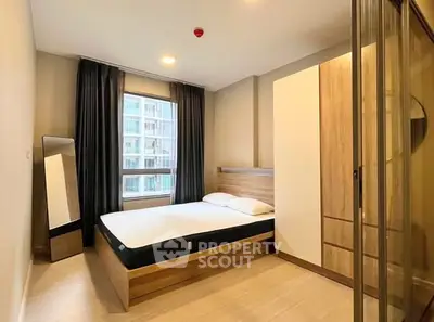 Modern bedroom with large window and stylish wooden furniture in a high-rise apartment.