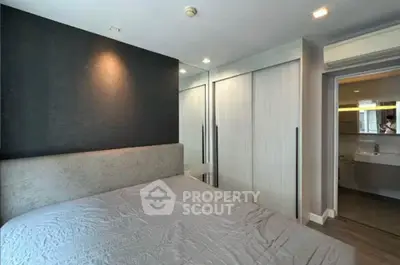 Modern bedroom with sleek design and mirrored closet doors