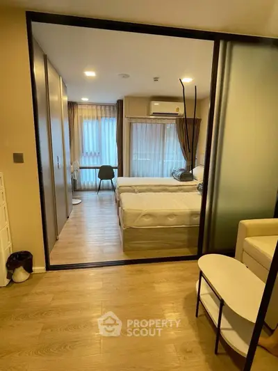Modern bedroom with sliding glass doors and cozy decor