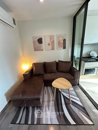 Modern living room with cozy brown sofa and stylish decor in a contemporary apartment.