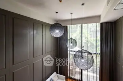 Elegant modern living room with large windows and stylish pendant lights