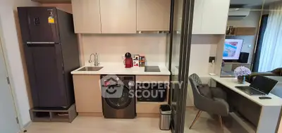 Modern kitchen with sleek appliances and adjacent study area, perfect for urban living.