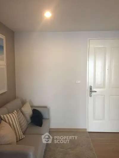 Cozy living room with modern sofa and soft lighting, perfect for relaxation.