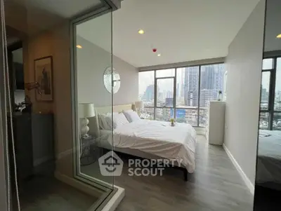 Modern bedroom with city view and large windows in high-rise apartment