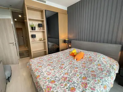 Cozy bedroom with floral bedding and modern decor in a stylish apartment.