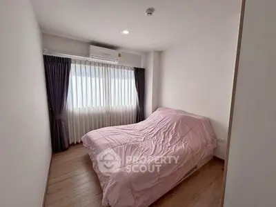 Cozy bedroom with natural light and modern decor in a stylish apartment.