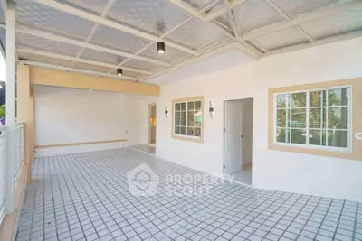 Spacious tiled balcony with modern lighting and large windows