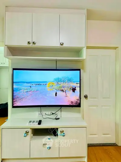 Modern living room with wall-mounted TV and stylish cabinetry
