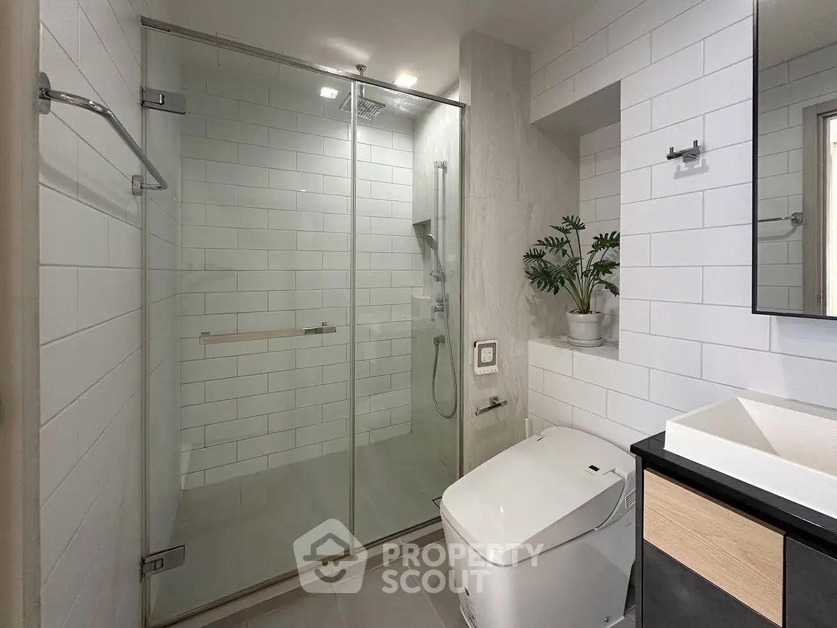 Modern bathroom with glass shower and sleek fixtures