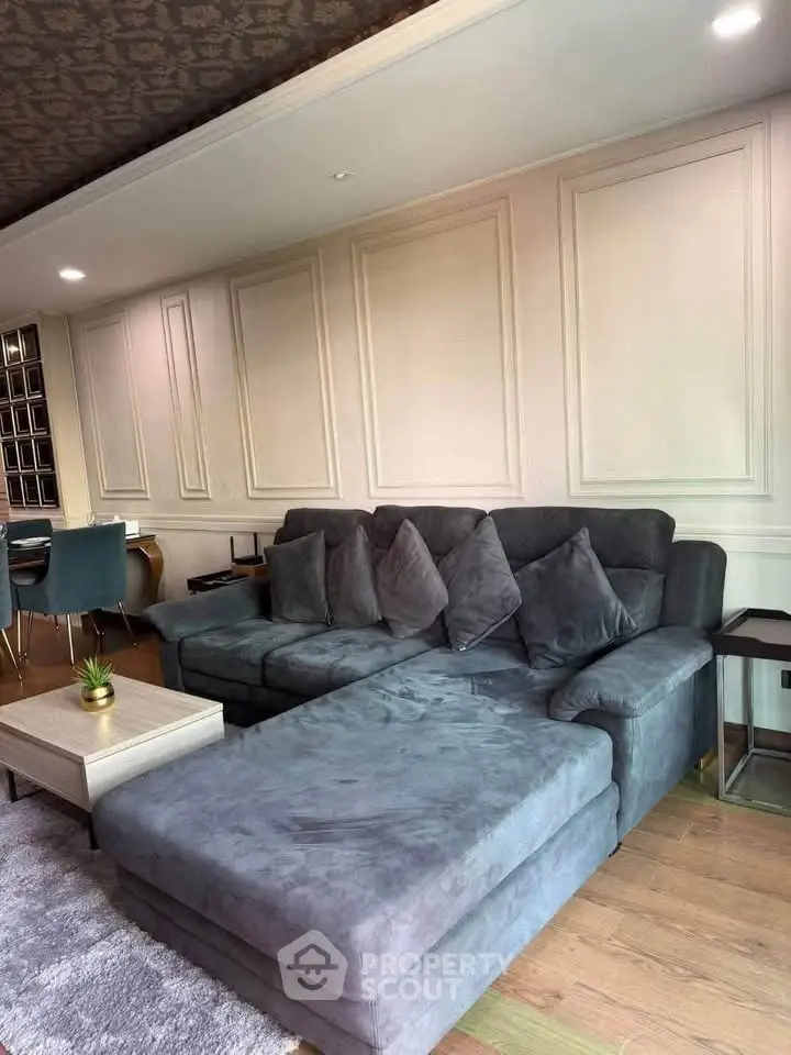 Spacious living room with elegant gray sectional sofa and stylish decor