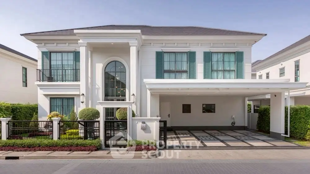 Elegant two-story house with modern architecture and spacious driveway in a serene neighborhood.