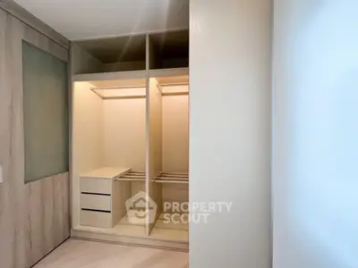 Spacious walk-in closet with modern design and ample storage space.