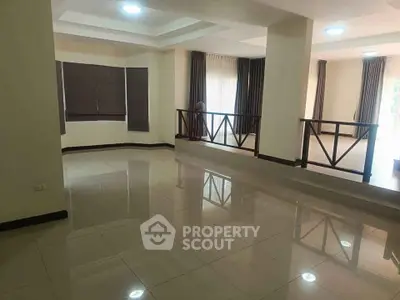 Spacious open-plan living area with large windows and modern design, perfect for family gatherings.
