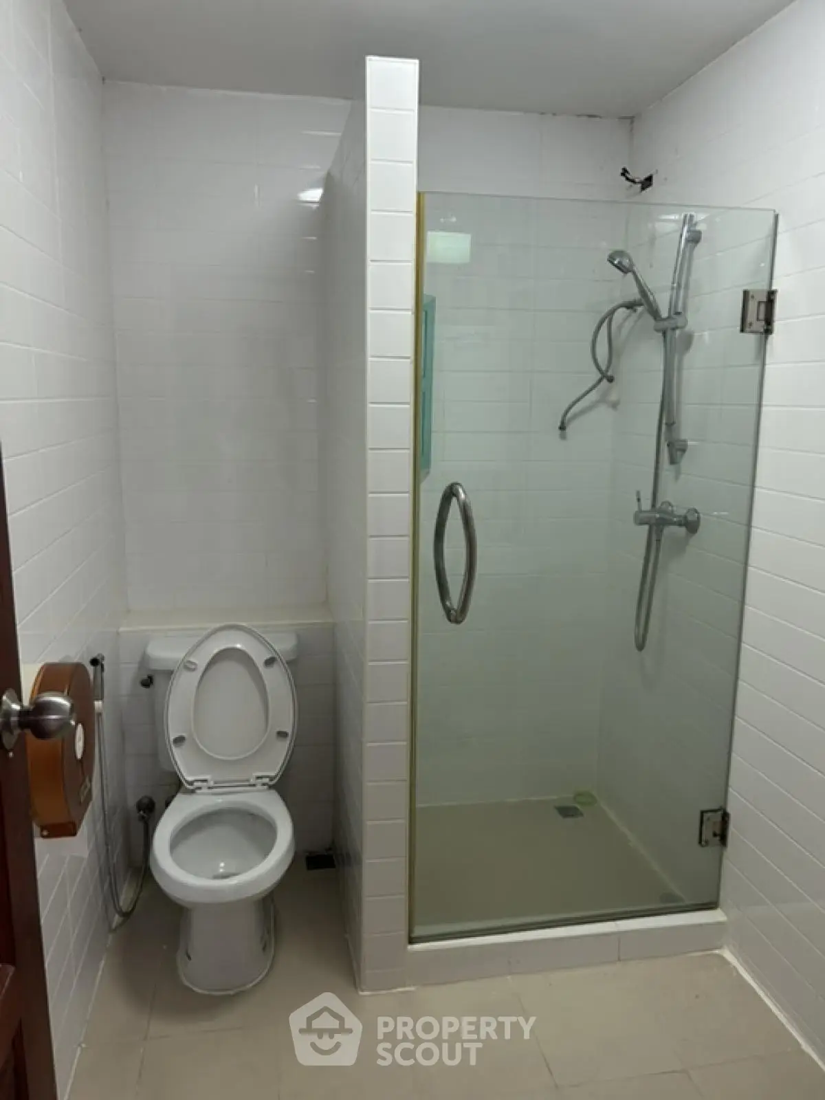 Modern bathroom with glass shower and white tiles