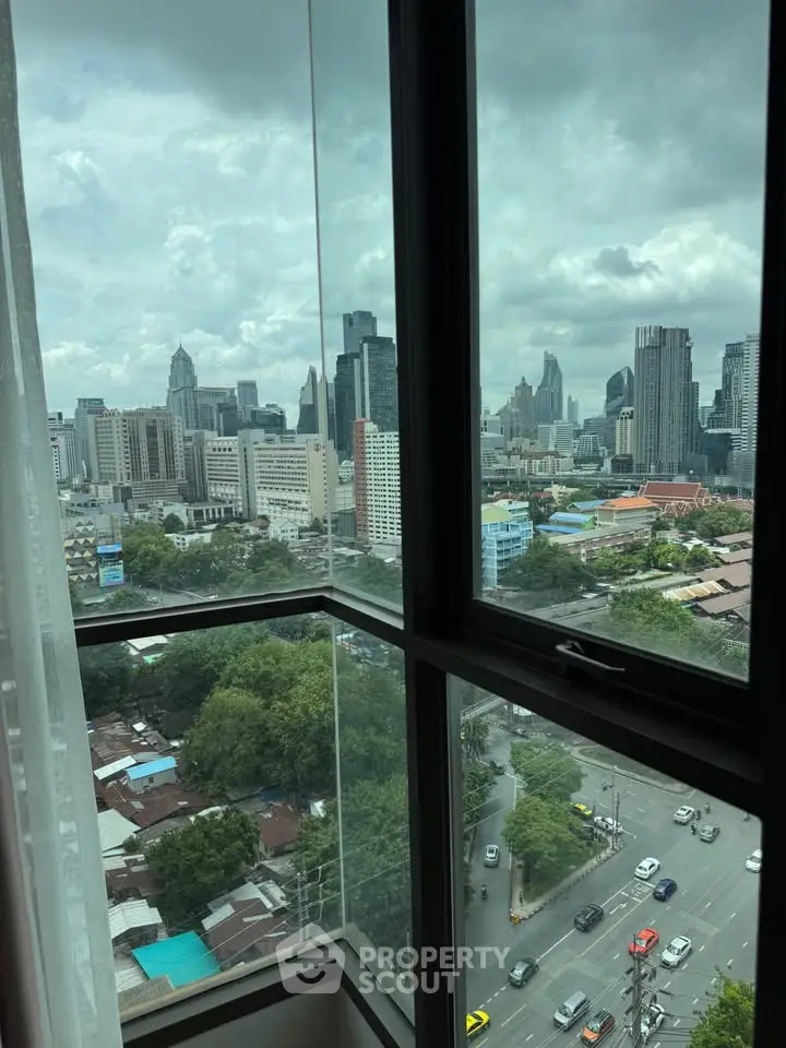 Stunning cityscape view from high-rise apartment window showcasing urban skyline.