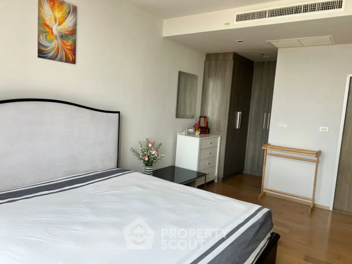 Spacious modern bedroom with elegant decor and ample storage space.