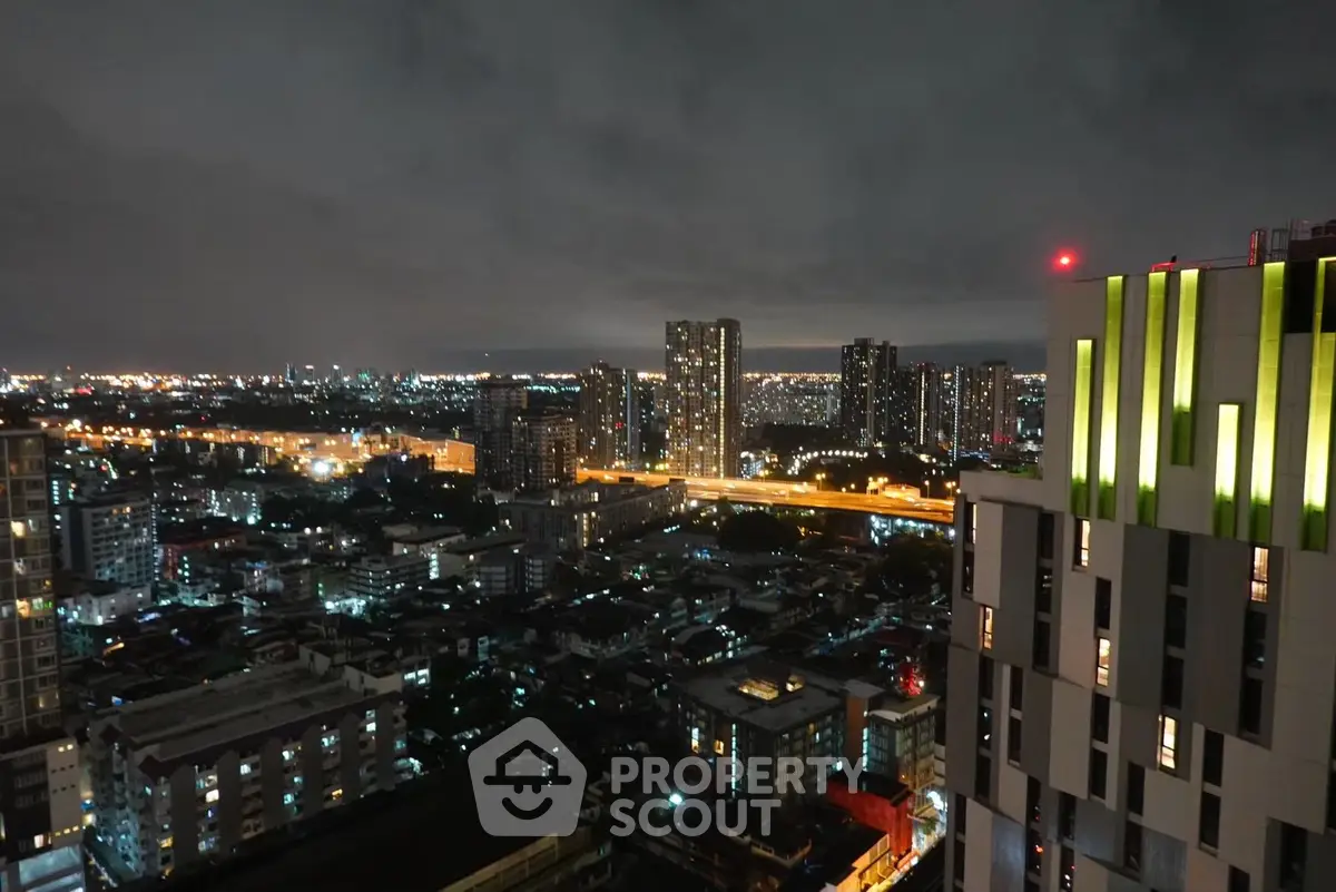 Stunning cityscape view from high-rise building at night with illuminated skyline.