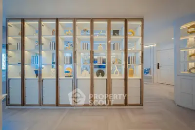 Elegant living room with illuminated display shelves showcasing modern decor