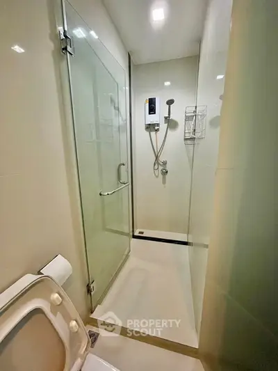 Modern bathroom with glass shower enclosure and sleek fixtures