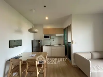 Modern open-layout kitchen and dining area with sleek design and natural lighting.