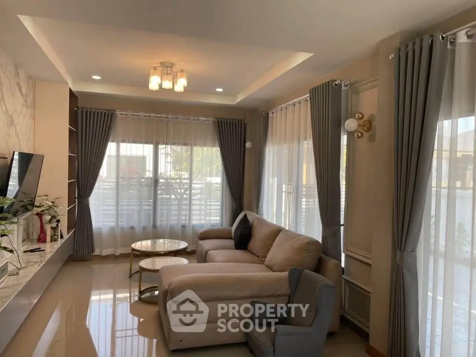 Elegant living room with cozy sectional sofa and large windows for natural light.